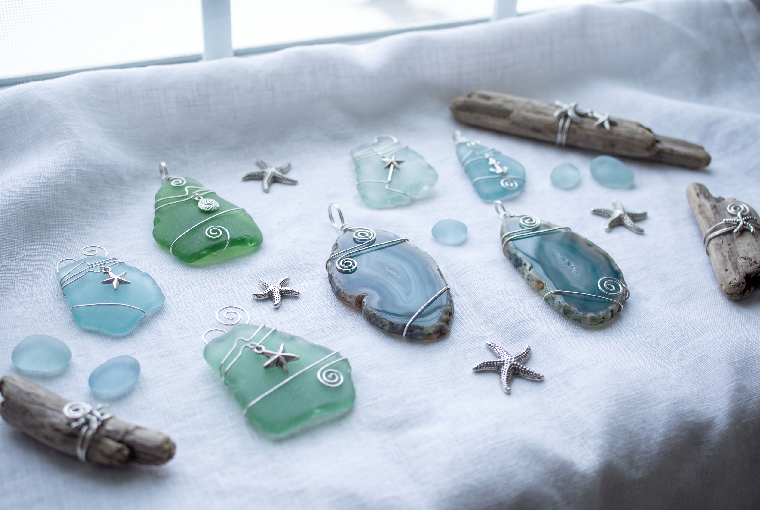 Wire-wrapped sea glass and agate slice ornaments