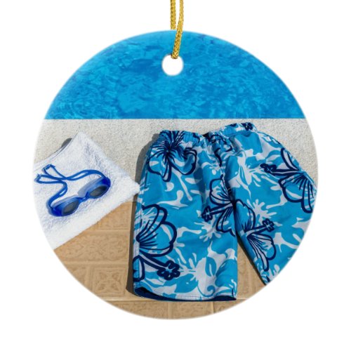 Swimming trunks goggles and towel at pool ceramic ornament